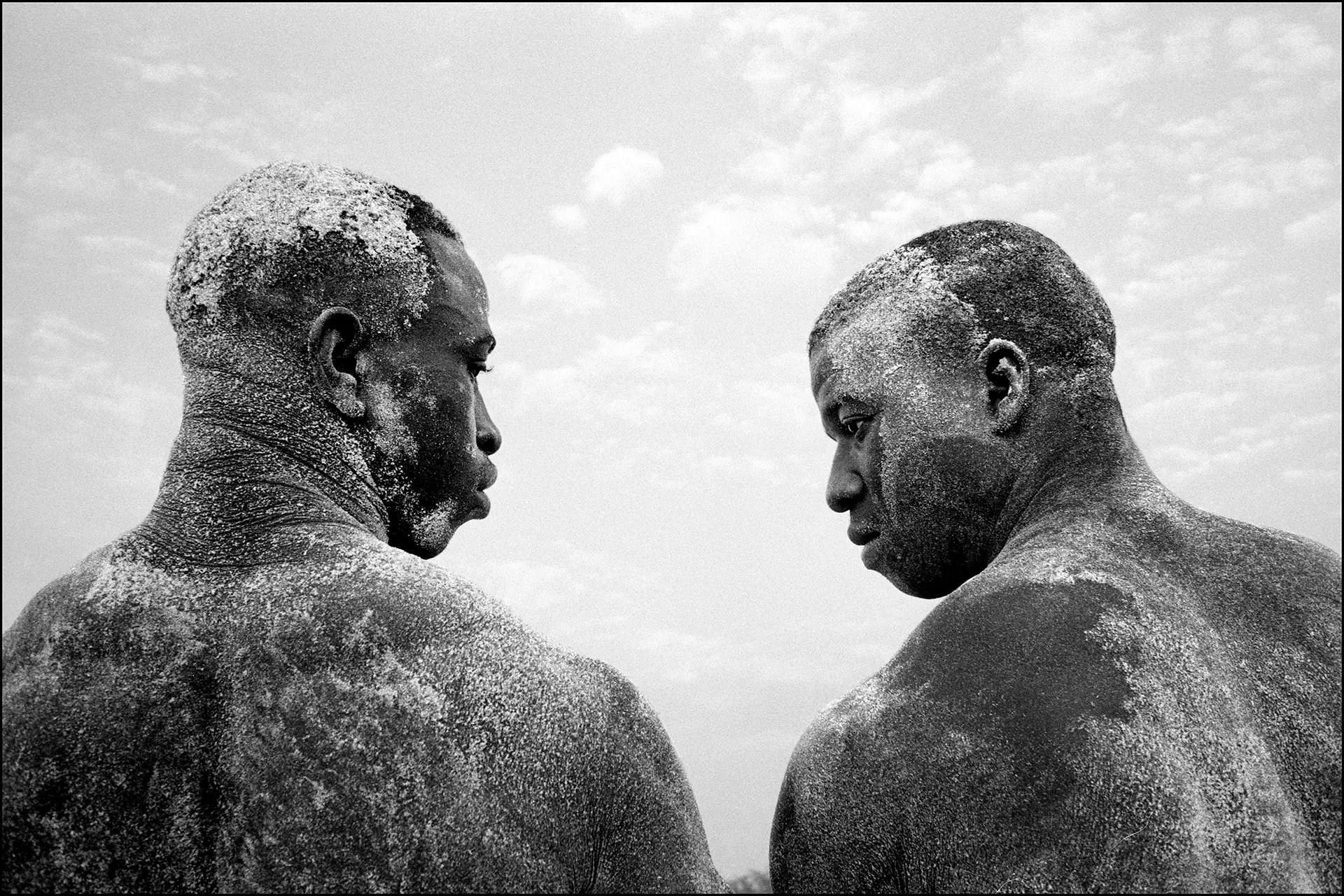 Two african men powdered with sand