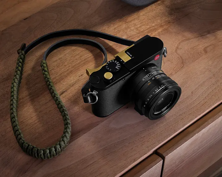 A Leica camera resting on a wooden table