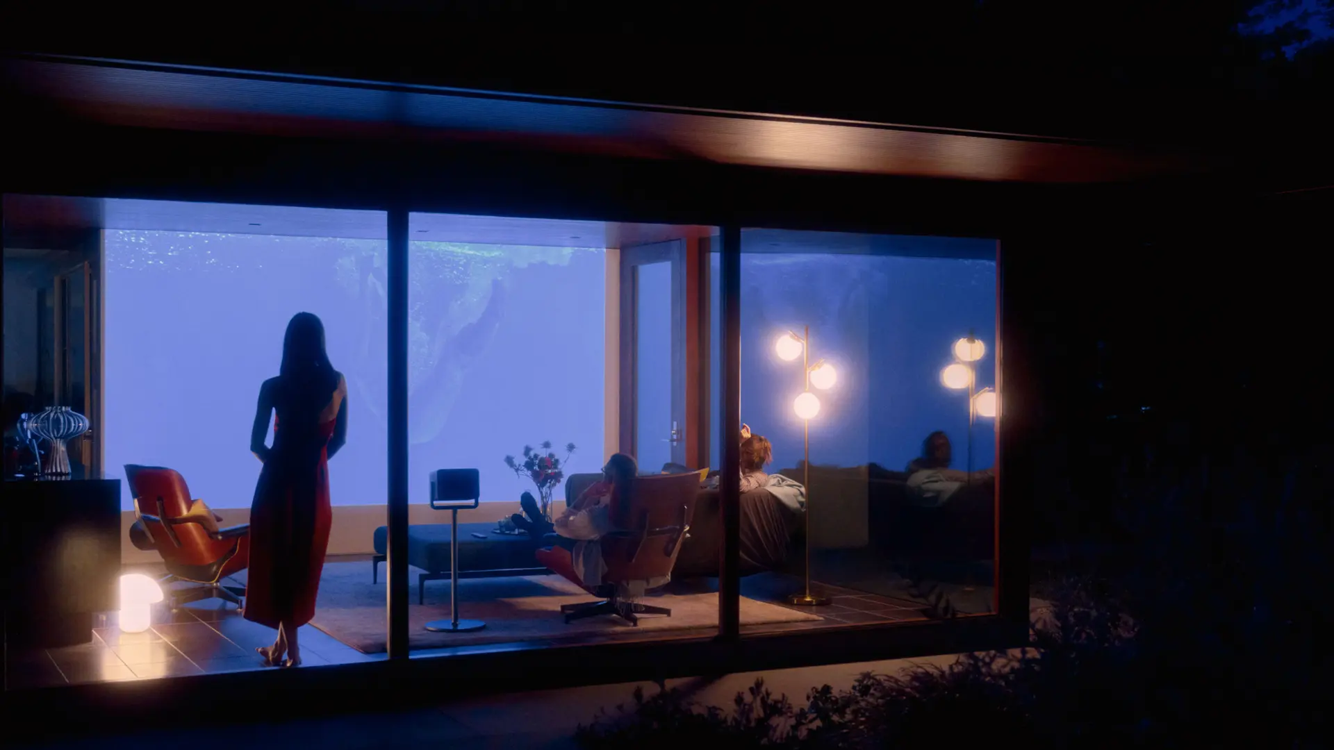 View from outside into a house where a Leica Cine Play 1 projection is going on.