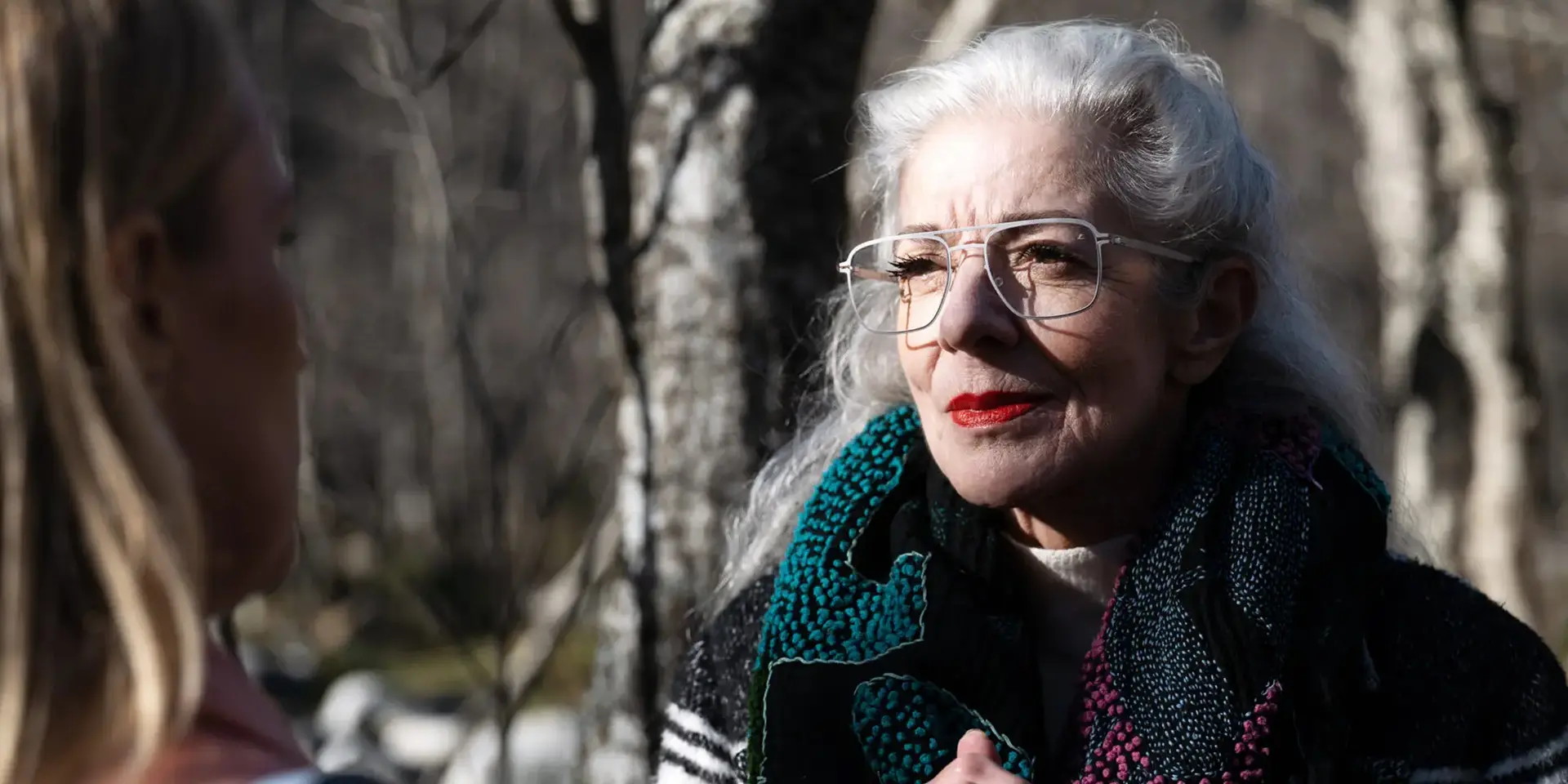 an elderly woman wearing glasses with Leica lenses