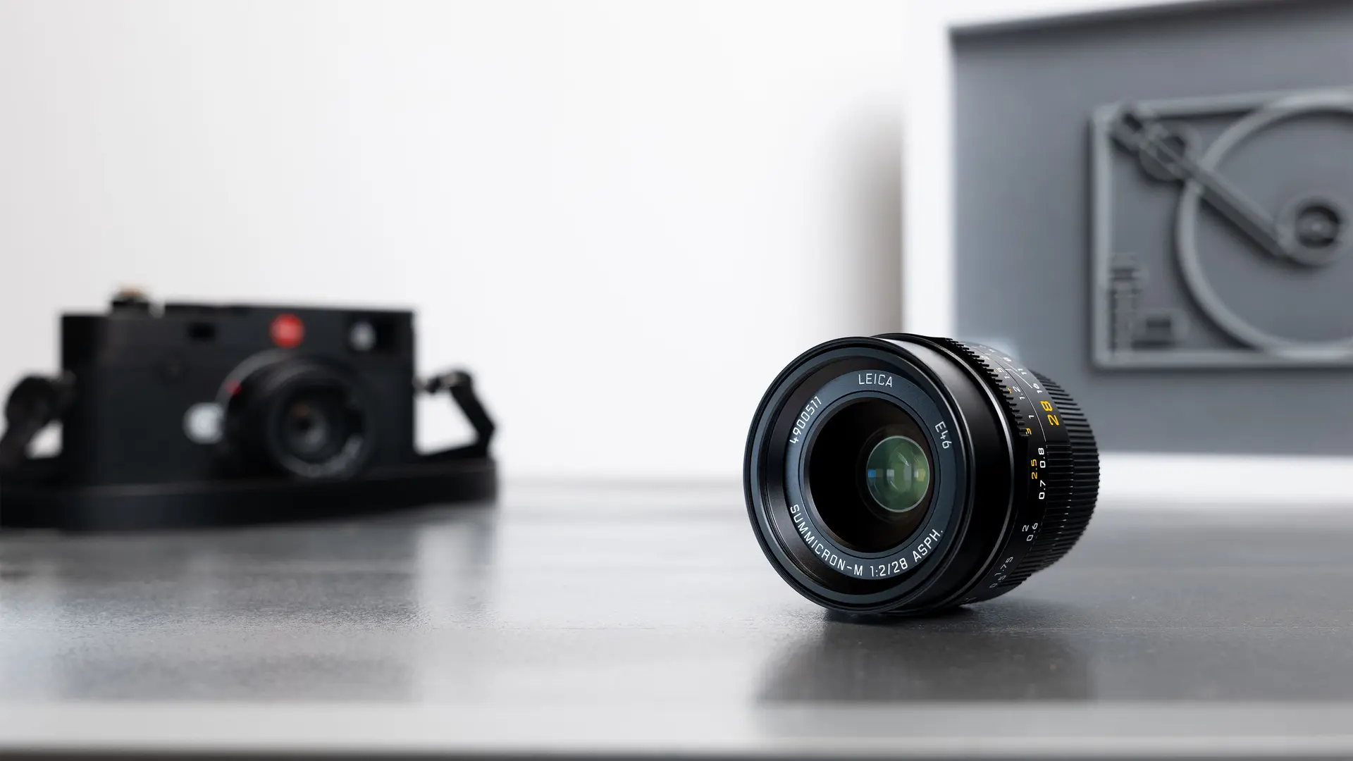 Leica camera with a lens on a table.