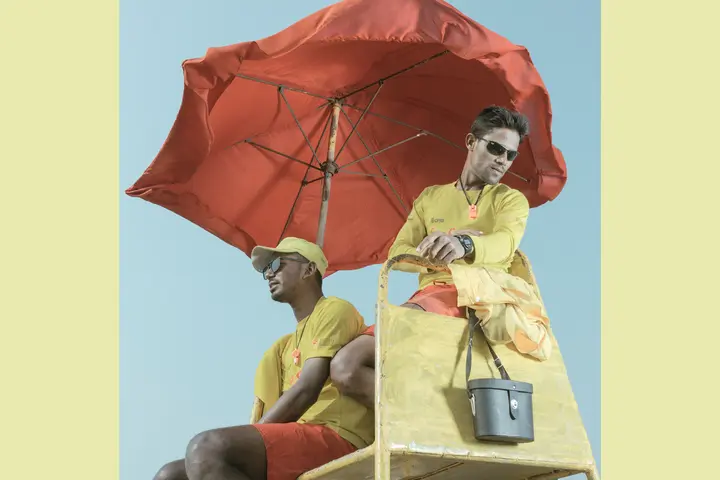 Men with yellow clothes at the beach