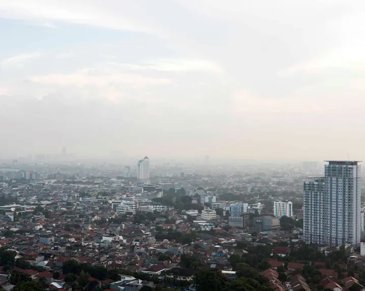 View of a foggy city with tower blocks.