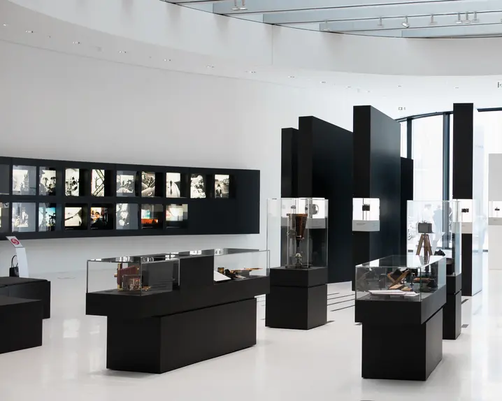 Exhibition hall with displays of historic cameras and photographs.