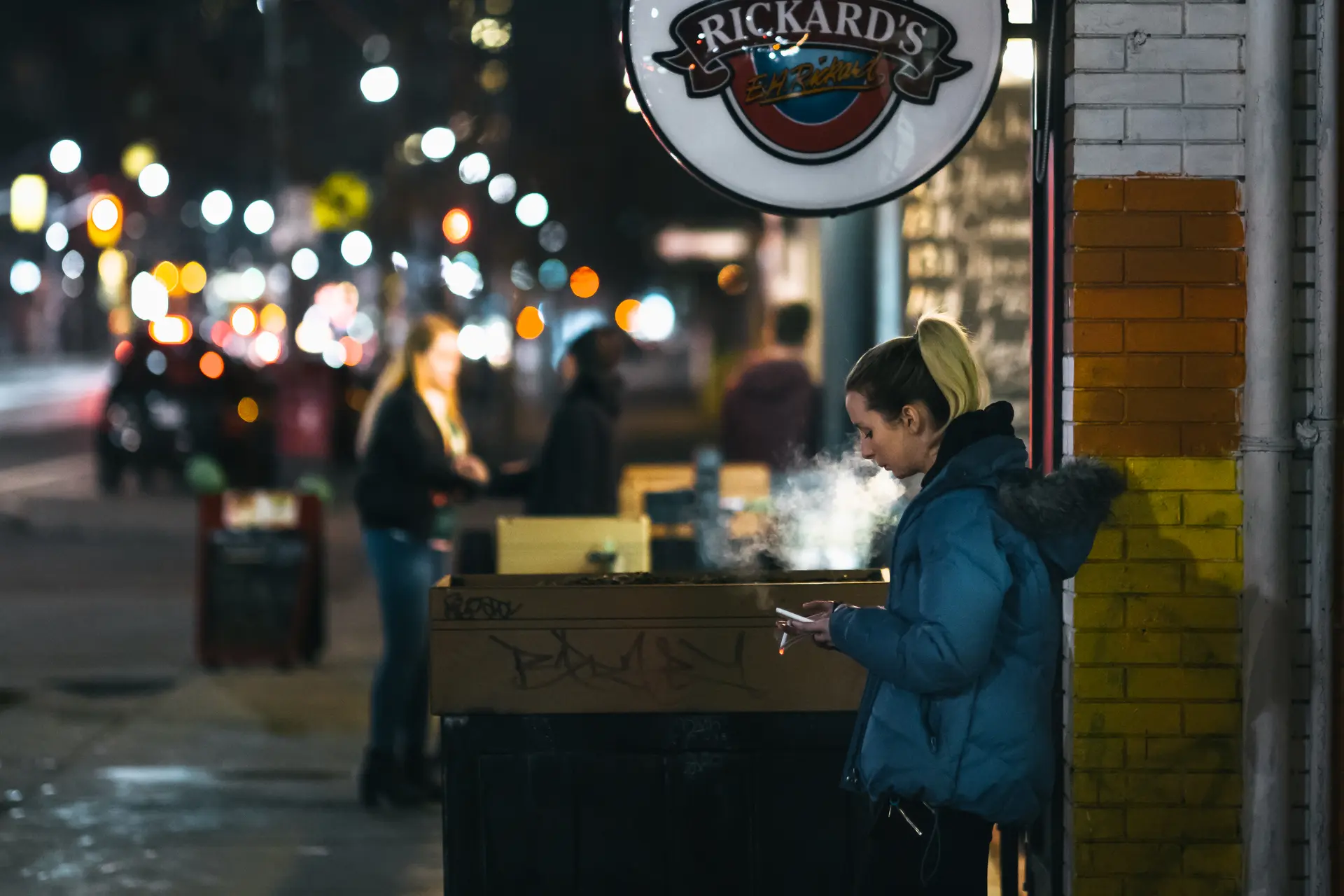 Smoking woman in front of pub