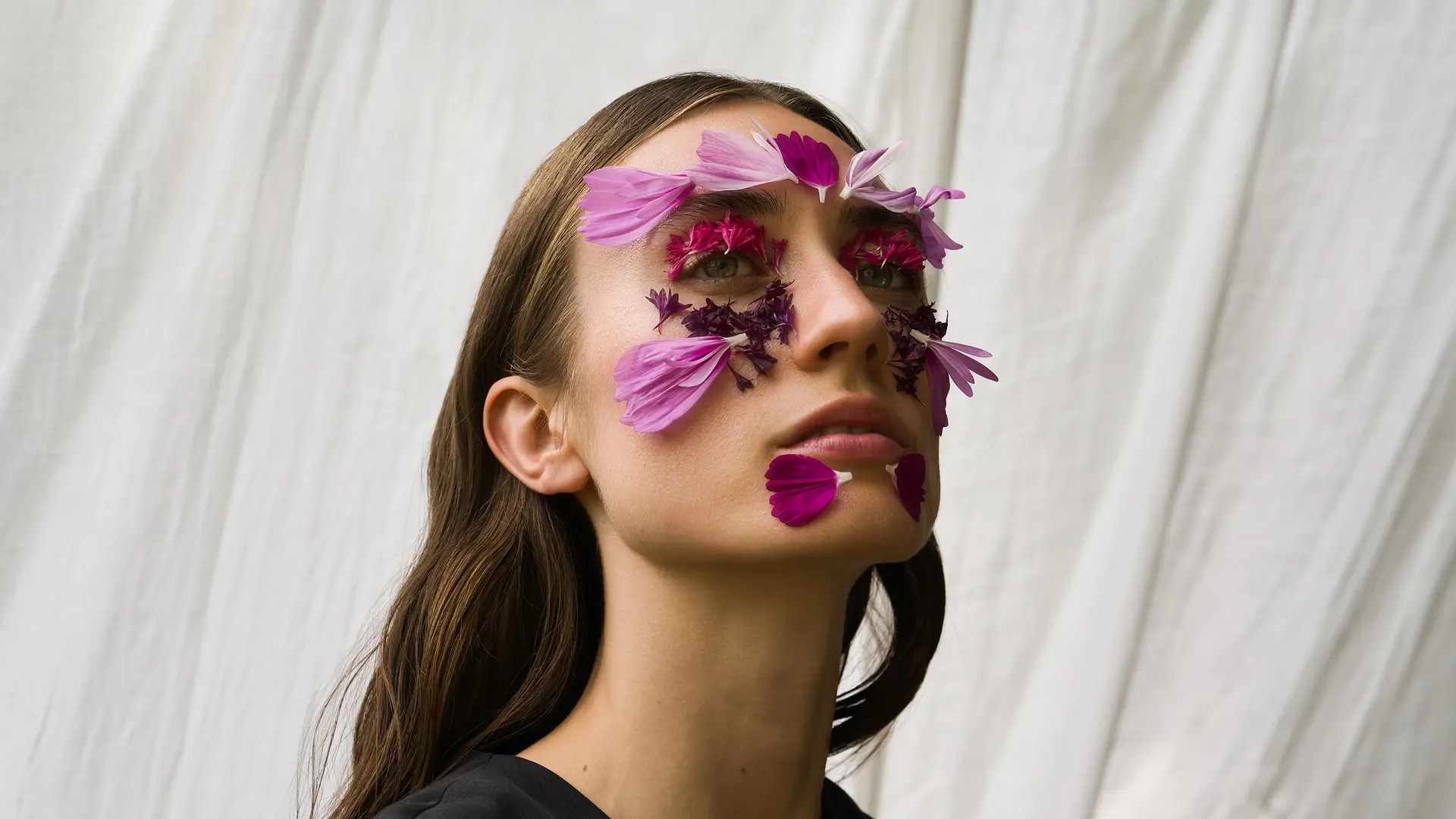 Portrait of a woman with flowers on her face skin