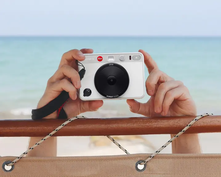 White Leica sofort Camera at the beach