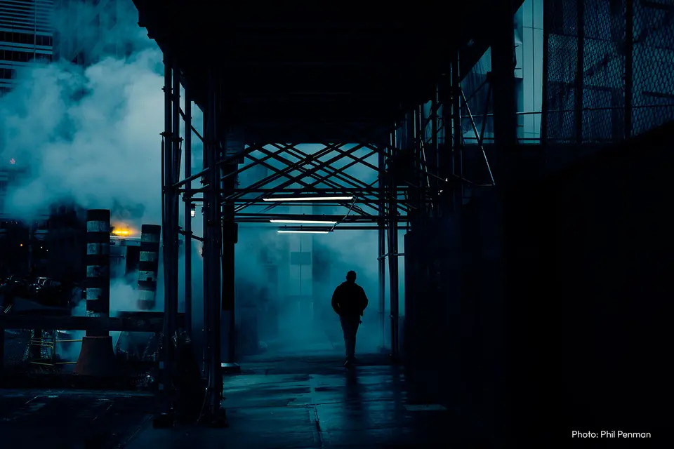 Man walking down the street at night