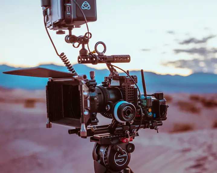 Professional camera equipment set up against a desert backdrop at dusk